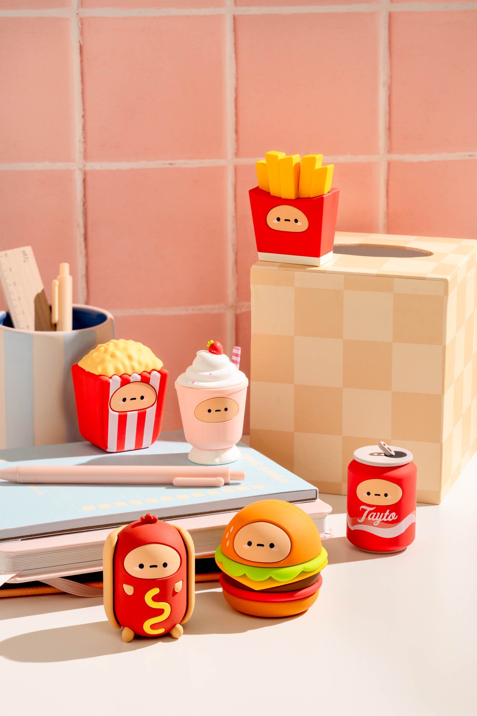 Fast food-themed novelty figurines on a white surface.
