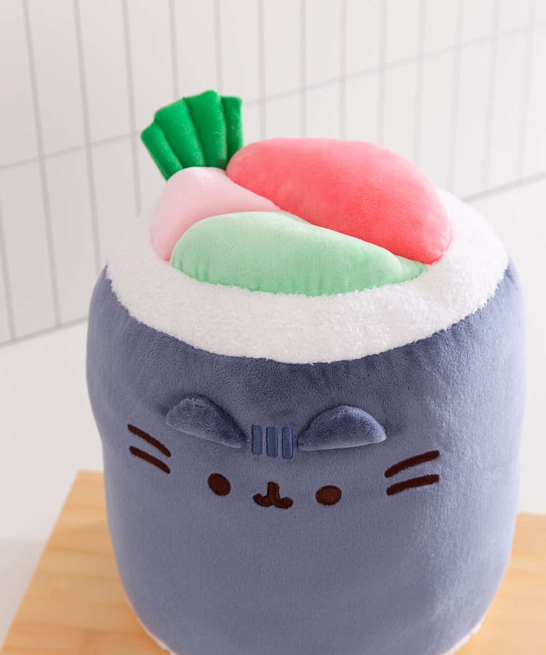 Plush toy resembling a cat with a sushi design on a white background
