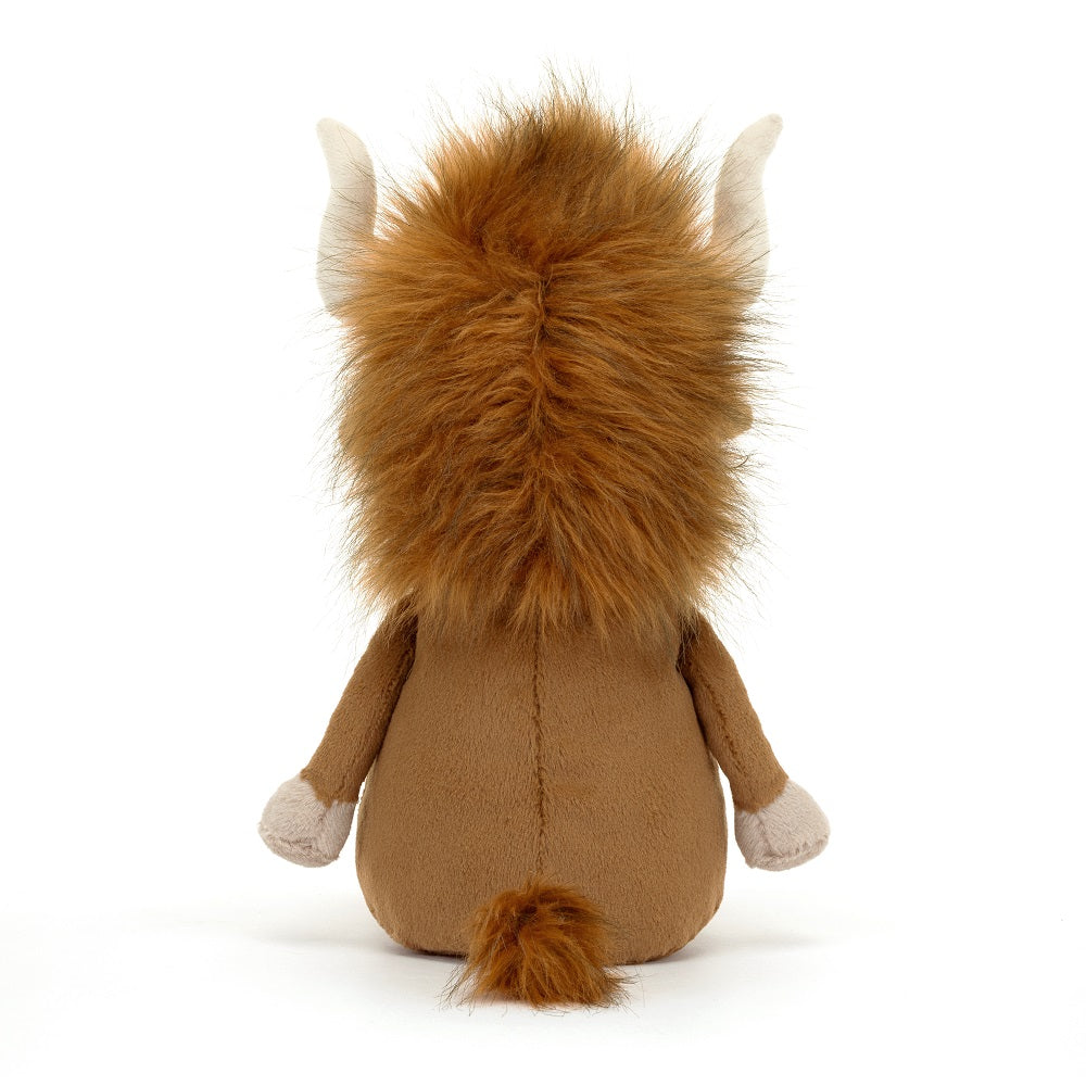 Back view of a brown stuffed highland cow with shaggy hair and horns, isolated on white.