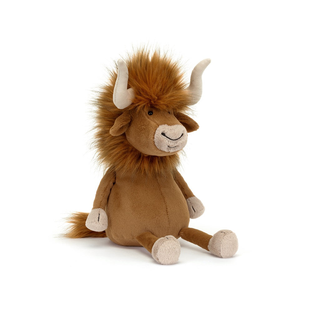 A stuffed brown bull sitting on a white background.