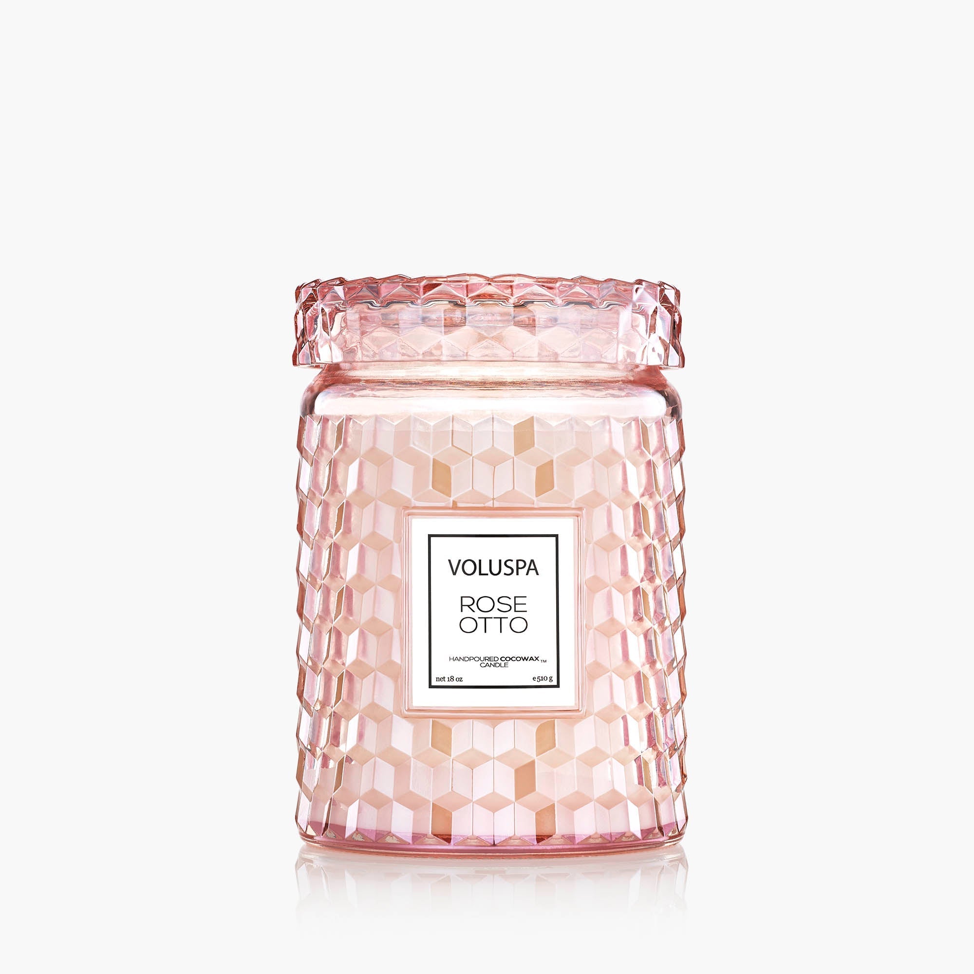 Pink textured candle jar with Voluspa label on a white background
