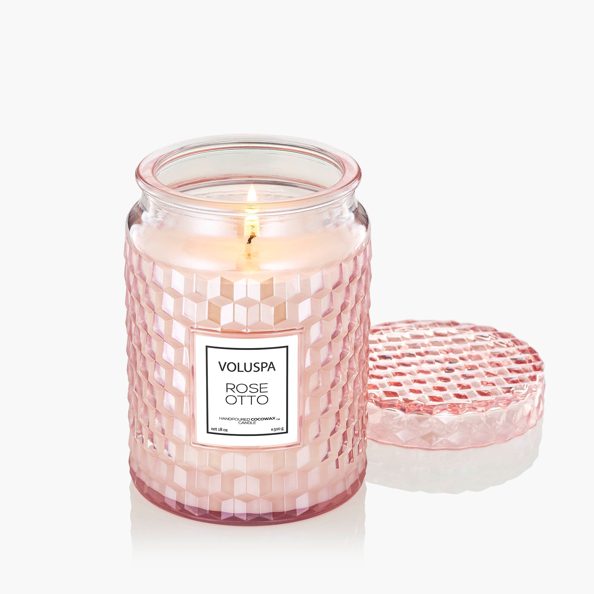 Pink candle with a label on a white background