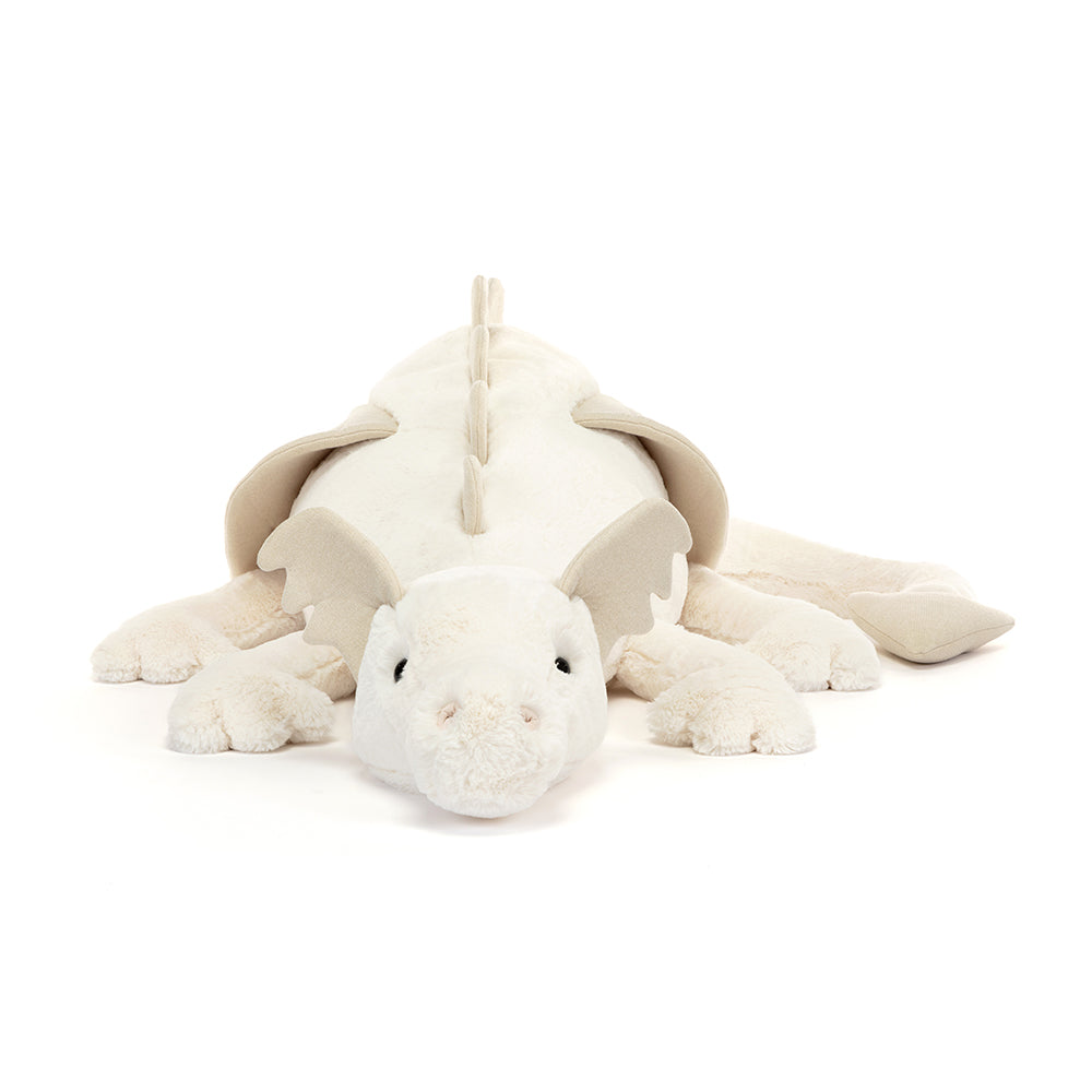 Cream-colored stuffed dragon, lying down.