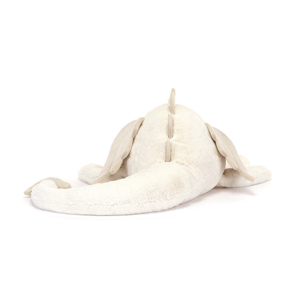 Rear view of a cream-colored plush dragon.