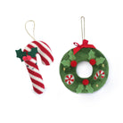 Christmas decorations: candy cane with holly and a green plush wreath.