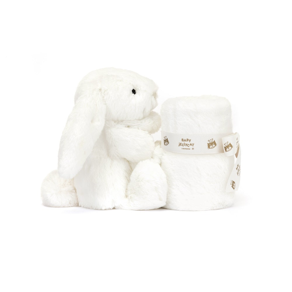 White plush bunny toy and rolled blanket with a branded ribbon.