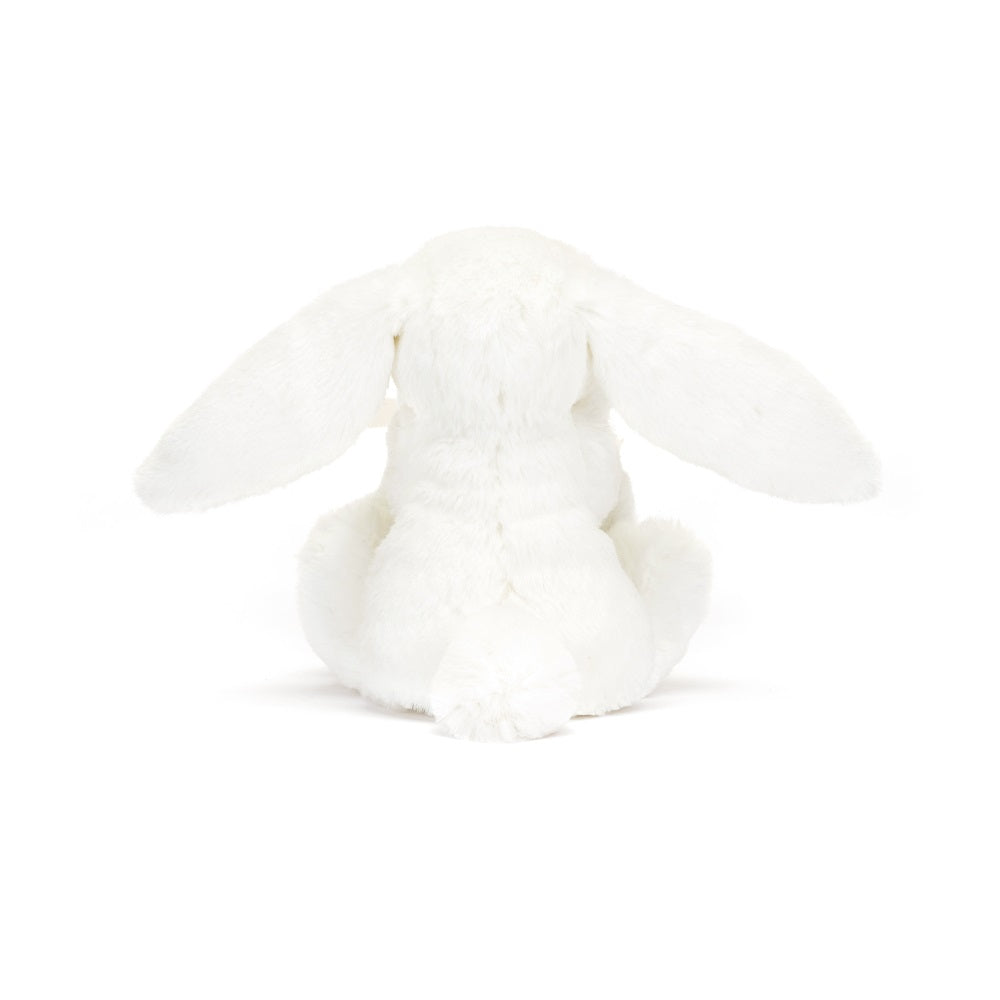 Back view of a white stuffed bunny.