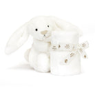 White bunny plush toy with a rolled-up blanket tied with a patterned ribbon.