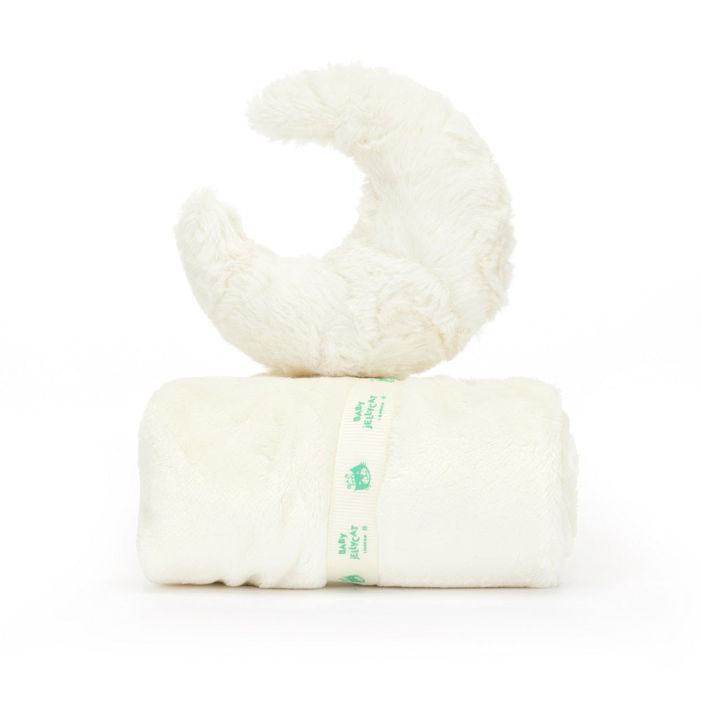 White baby blanket and moon-shaped plush toy.