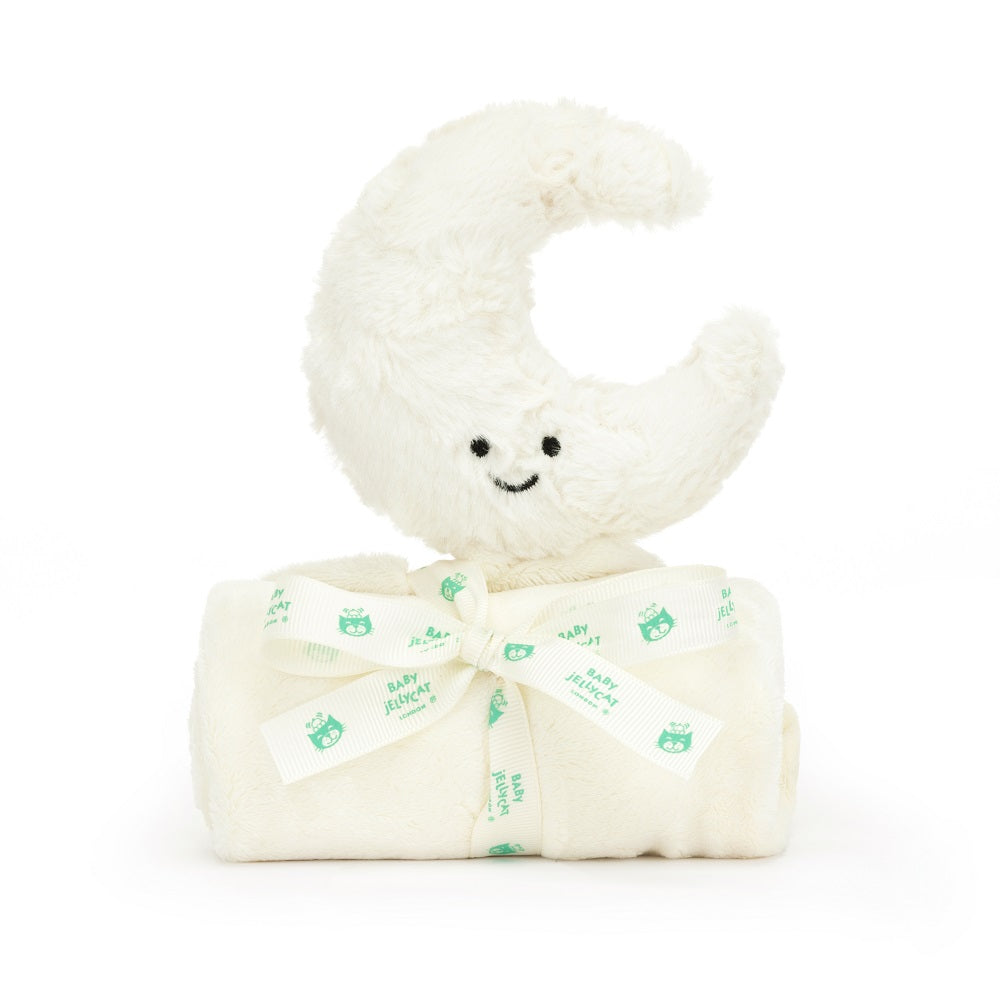 Close-up of a plush, cream-colored crescent moon toy with a cute, smiling face, sitting atop a rolled-up cream-colored baby blanket tied with a matching ribbon decorated with a baby owl logo.