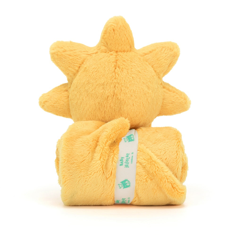 Yellow plush sun toy with a blanket wrapped around it, secured with a white Baby Jellycat ribbon.