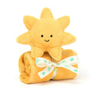 A yellow stuffed sun toy sits on top of a rolled-up yellow plush blanket tied with a white ribbon.
