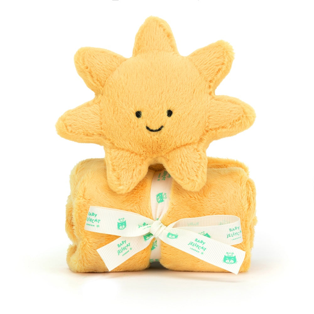 A yellow plush sun toy sits on a yellow blanket tied with a white ribbon.