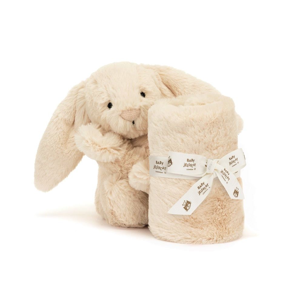 Cream-colored stuffed bunny and rolled blanket tied with a "Baby Jellycat" ribbon.