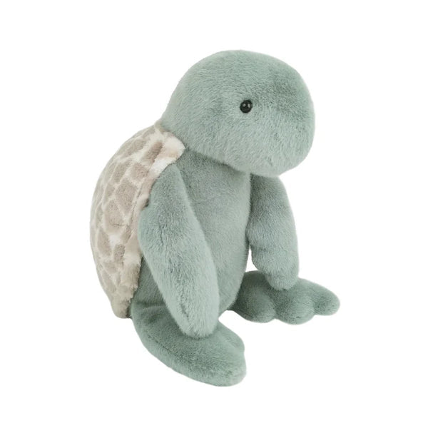 Soft plush turtle toy in light green with a patterned beige shell.