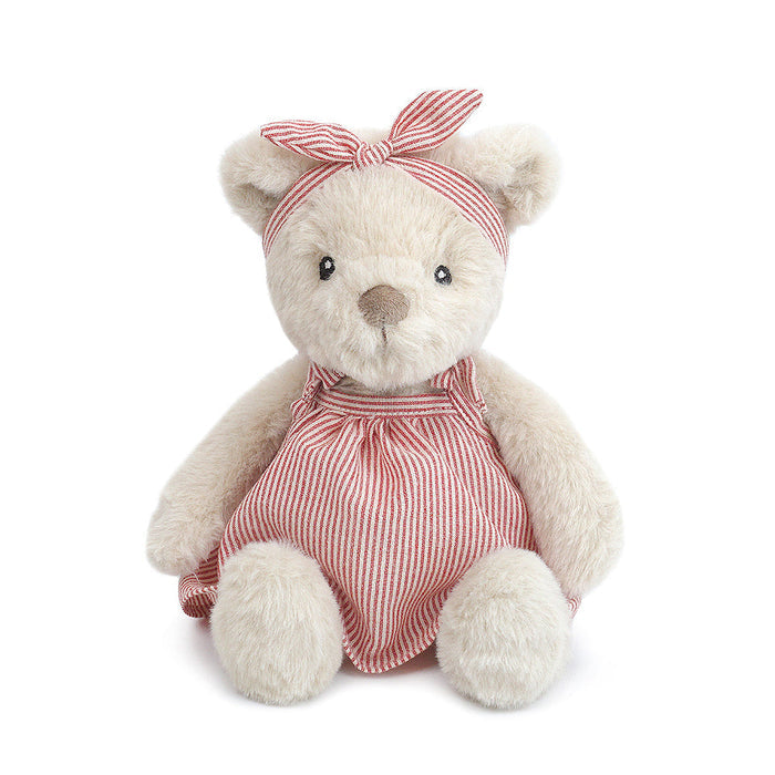 Stuffed teddy bear wearing a red and white striped dress and headband.