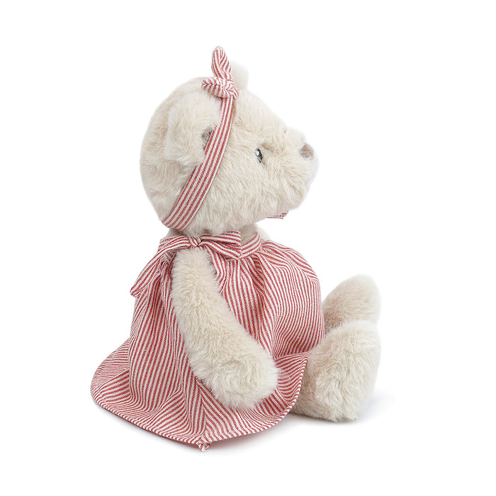 Cream-colored teddy bear with a red-and-white striped dress and headband.