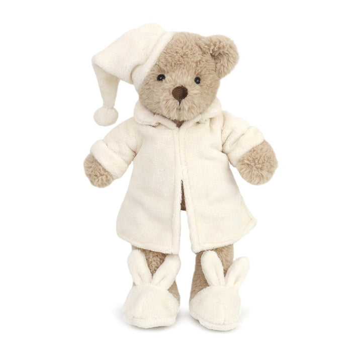 Teddy bear wearing pajamas, nightcap, and bunny slippers.