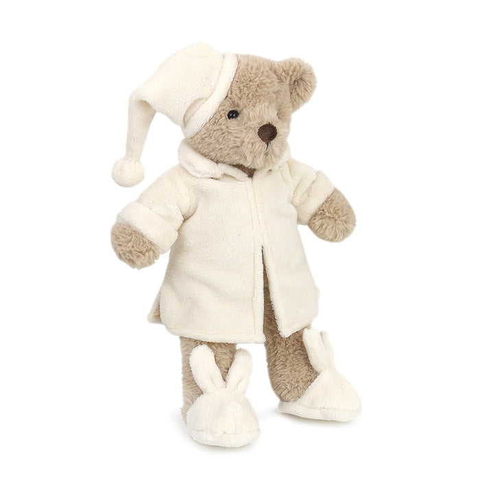 Stuffed teddy bear wearing pajamas, nightcap, and bunny slippers.