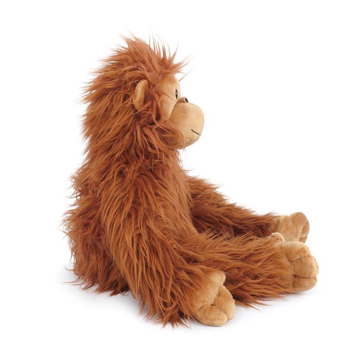 Brown, furry, plush toy orangutan sitting.