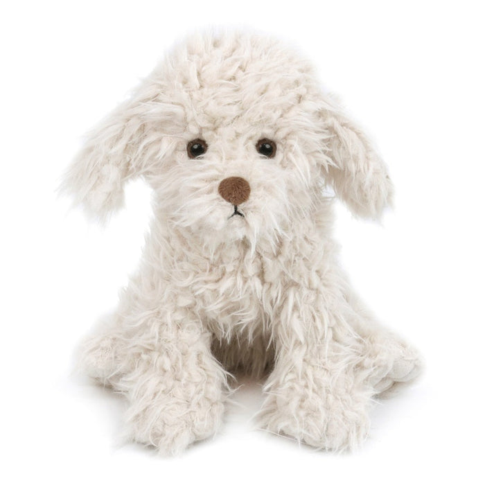 Stuffed white dog with brown nose and eyes.