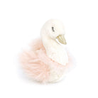 A stuffed swan toy with a golden beak and a pink tutu.