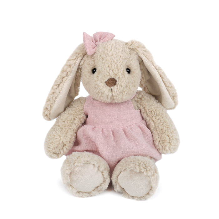 A stuffed bunny wearing a pink dress and a pink bow on its head.