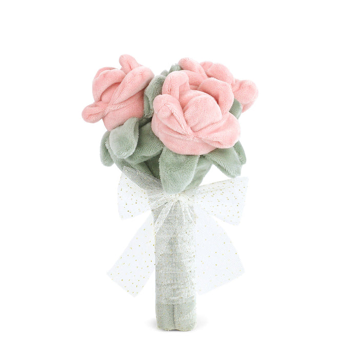 Stuffed pink rose bouquet with green leaves and a white bow.