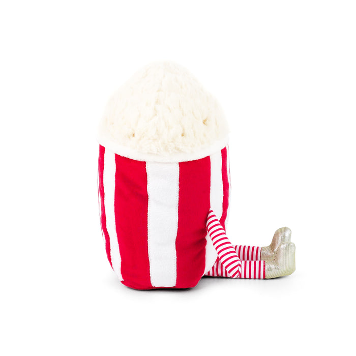Stuffed popcorn bucket toy with striped legs and gold shoes.