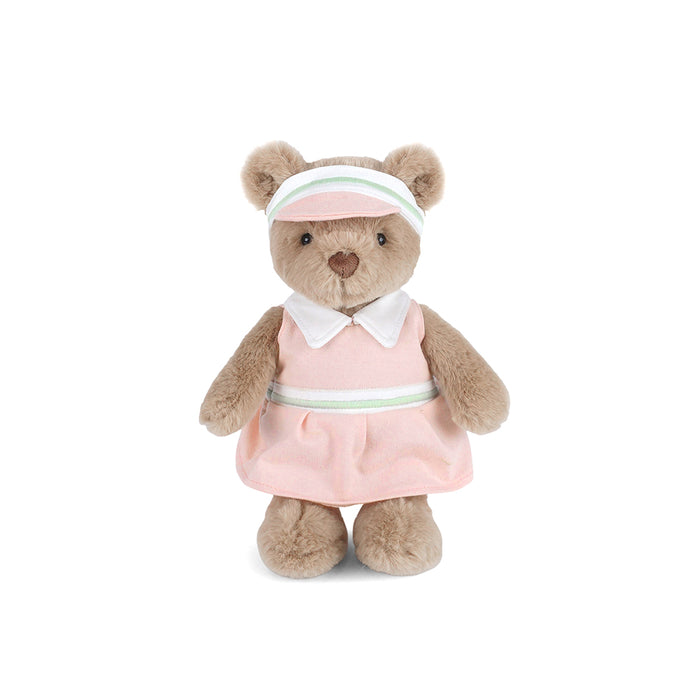Stuffed teddy bear wearing a pink dress and headband on a white background