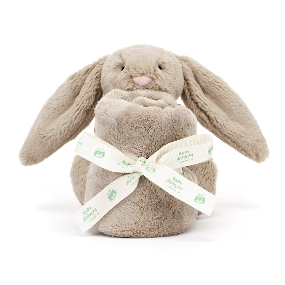 Tan stuffed rabbit wrapped in a blanket with a "Baby Jellycat" ribbon.