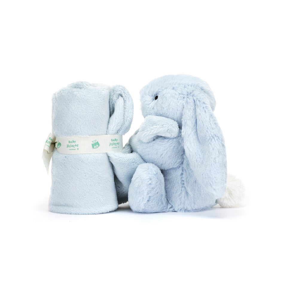 Blue stuffed bunny toy and rolled blanket.