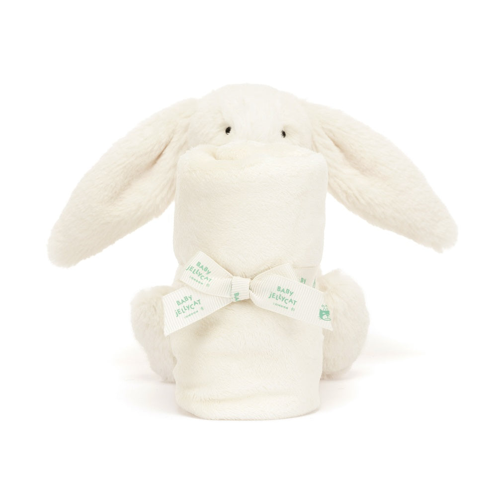 White bunny plush toy with rolled-up blanket, tied with a bow.