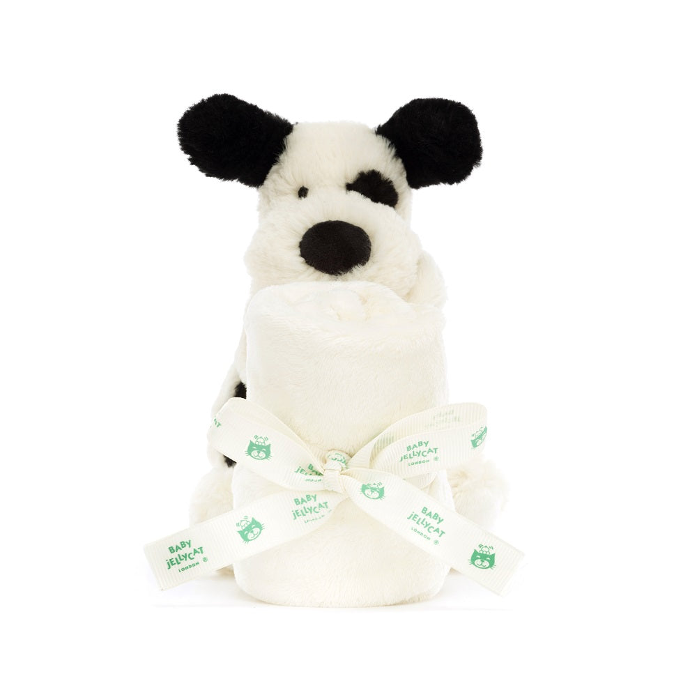 Stuffed dog and rolled blanket tied with ribbon.
