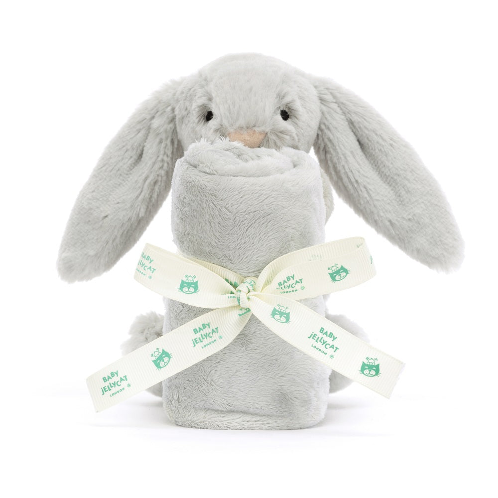Grey bunny plush with rolled blanket and branded ribbon.