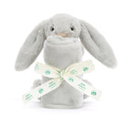 Grey bunny plush with rolled blanket and branded ribbon.