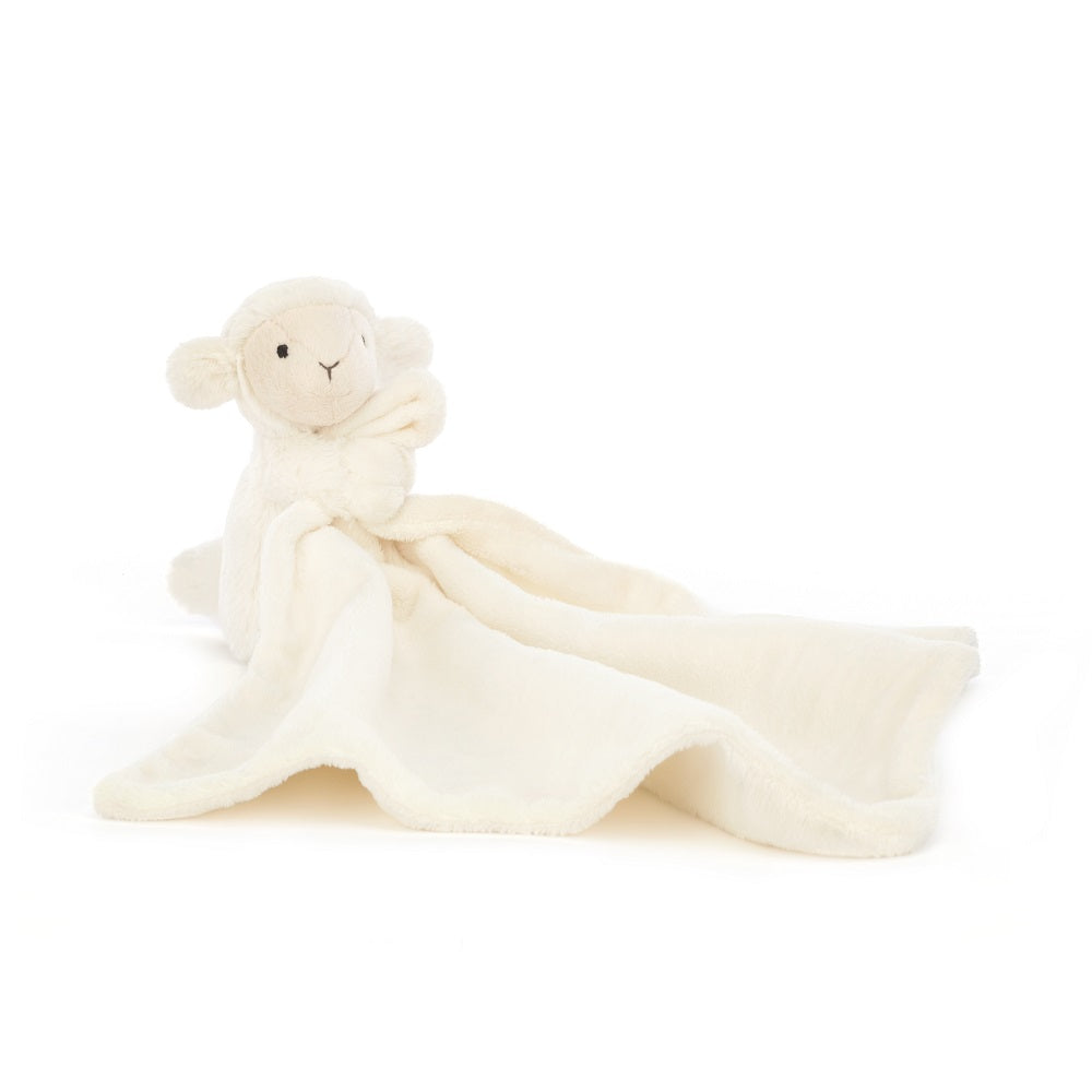 Cream-colored plush lamb with a blanket attached.