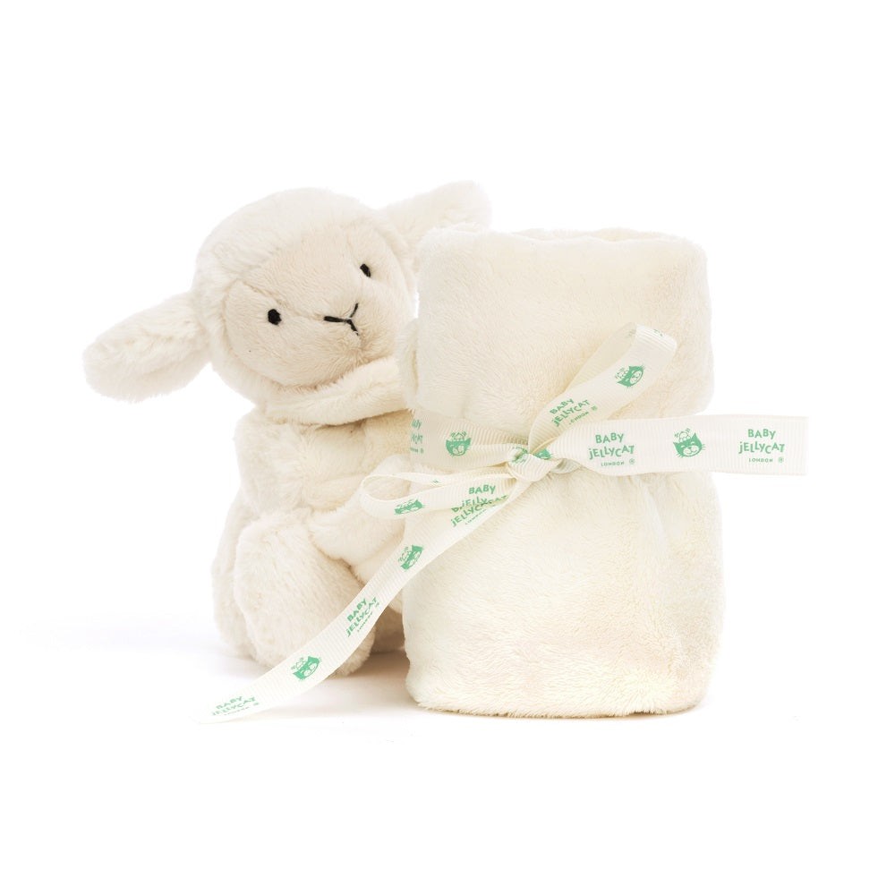 Stuffed lamb with cream blanket wrapped in ribbon.