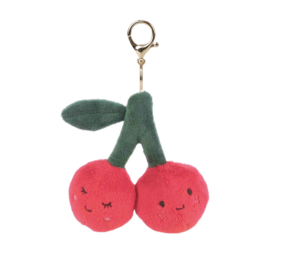 Plush cherry keychain with a green stem on a white background