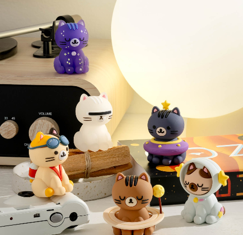 Six cat figurines in space-themed outfits.