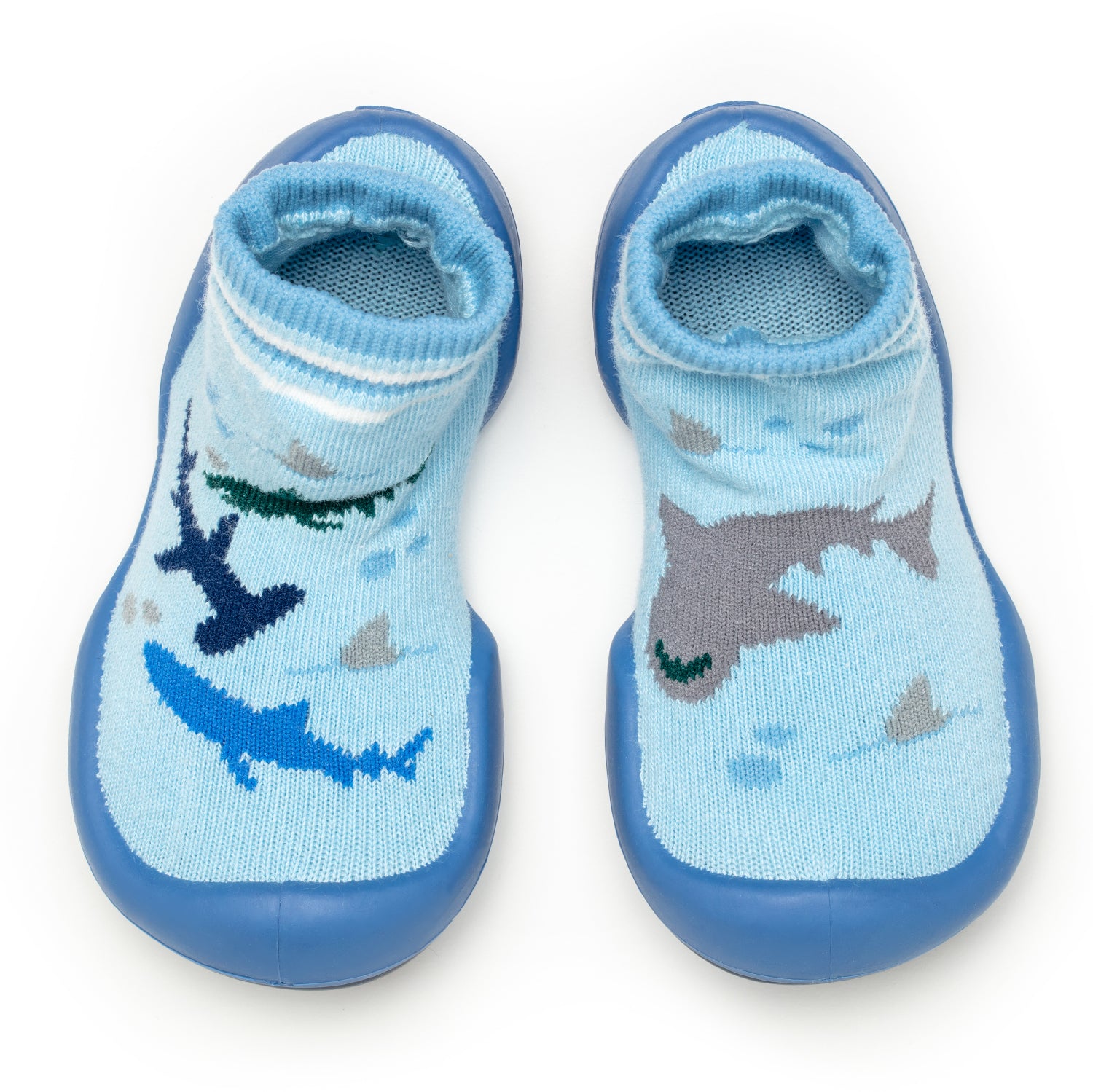 Two blue socks with rubber soles, patterned with sharks.