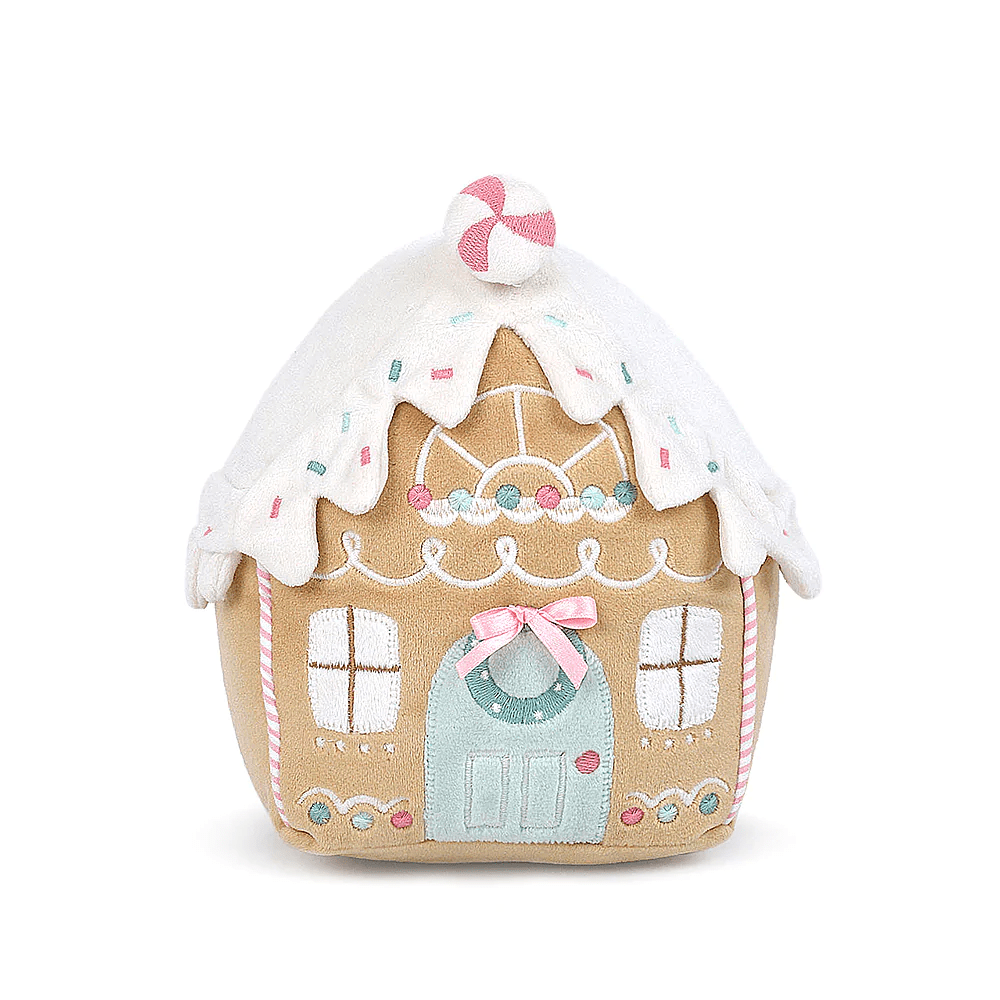 Plush toy gingerbread house with candy cane on top.