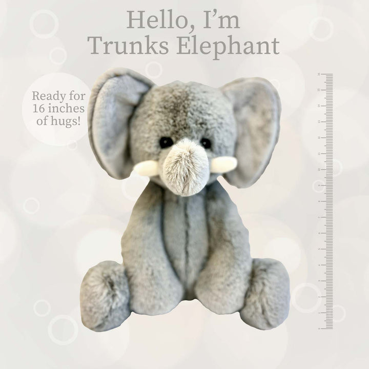 Gray plush elephant toy with white tusks sitting upright.
