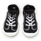 Two black and white baby sock-shoes.