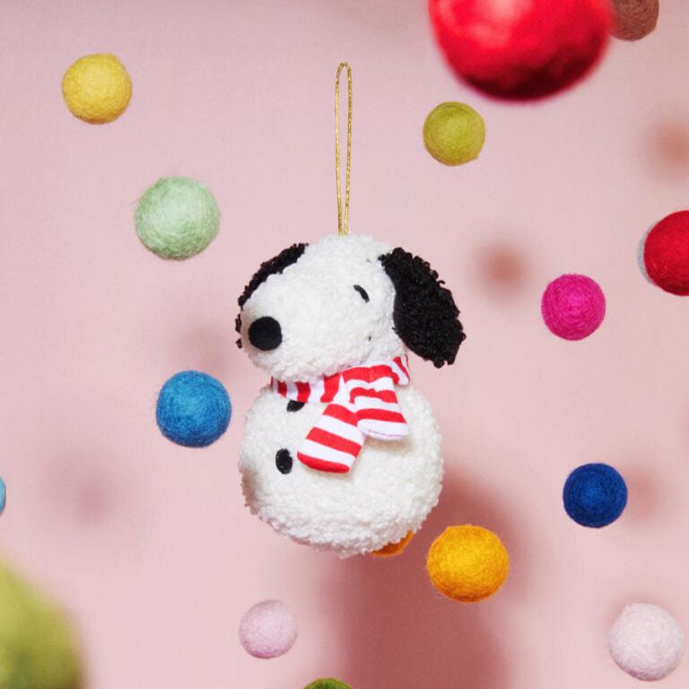 Plush Snoopy Christmas ornament with striped scarf.