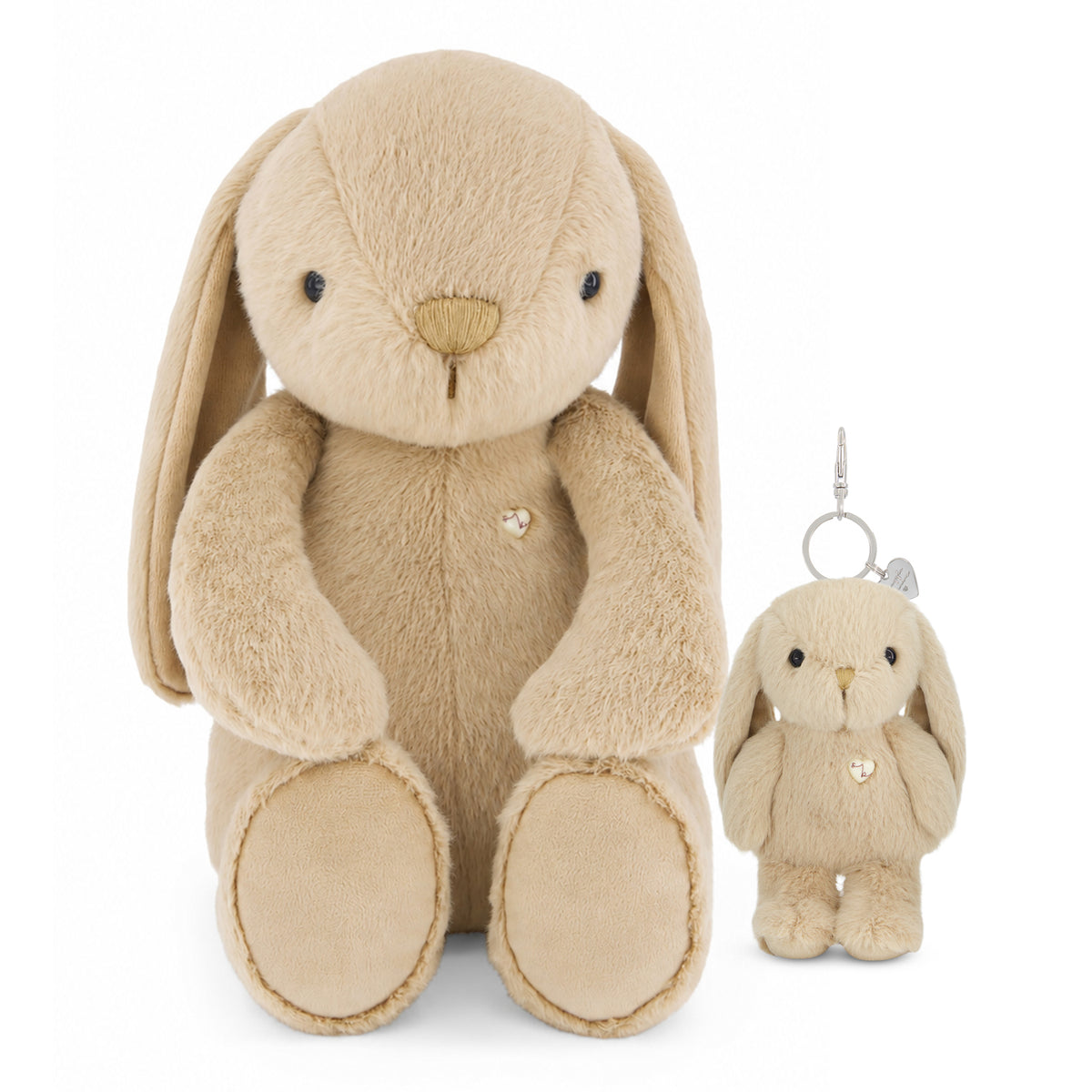 A beige plush bunny toy with long floppy ears, black bead eyes, and a small rhinestone chest ornament, shown next to a matching mini keychain with a silver metal clip.