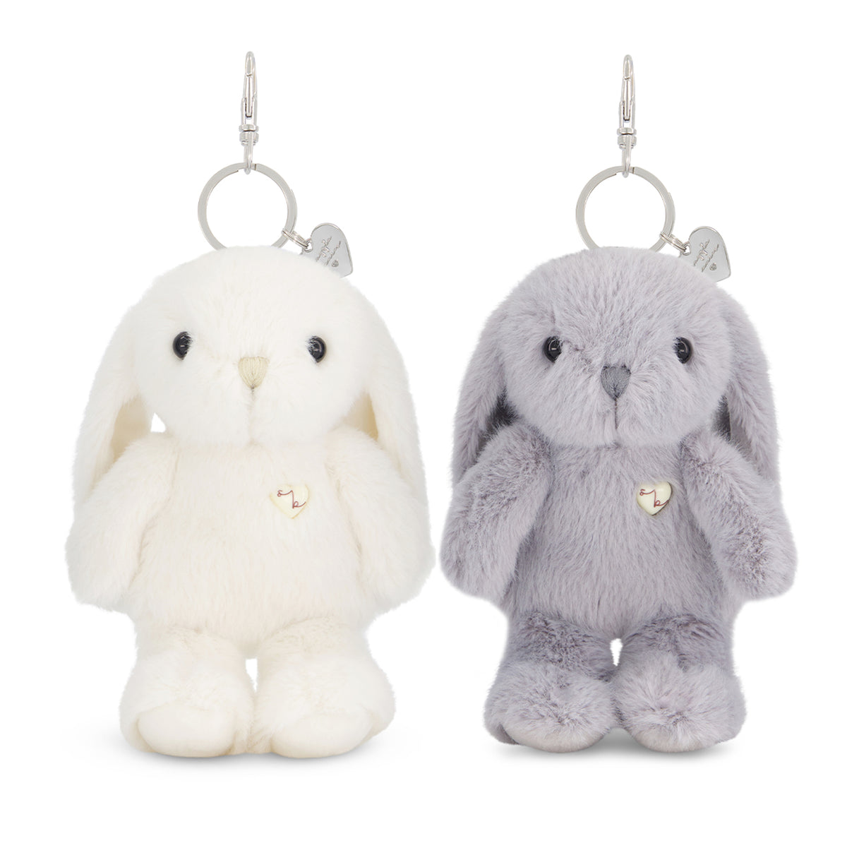 Two plush bunny keychains side by side on a white background, one cream white and one light gray, both with small gold heart charms and silver metal key rings.