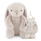 Two beige plush rabbits, one larger and sitting, the other a keychain size.