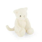 Cream-colored stuffed cat toy sitting.