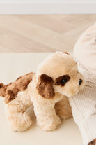 Tan and brown stuffed toy dog.